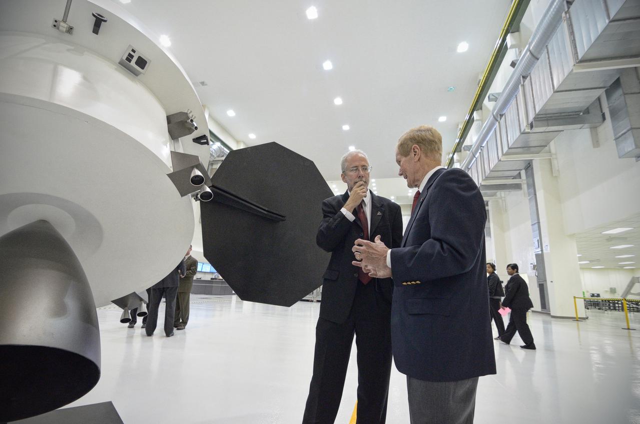 The Orion crew module pressure vessel for Exploration Flight Test-1 (EFT-1) is unveiled at a ceremony at the Operations and Checkout (O&amp;C) Building at NASA’s Kennedy Space Center in Florida on July 2, 2012. Orion Program Manager Mark Geyer is visible talking to others. Part of Batch image transfer from Flickr. 