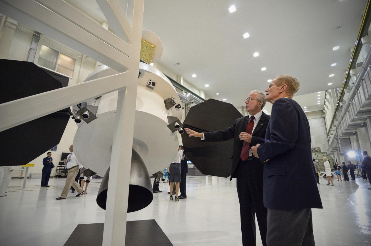 The Orion crew module pressure vessel for Exploration Flight Test-1 (EFT-1) is unveiled at a ceremony at the Operations and Checkout (O&amp;C) Building at NASA’s Kennedy Space Center in Florida on July 2, 2012. Orion Program Manager Mark Geyer is visible talking to others. Part of Batch image transfer from Flickr. 
