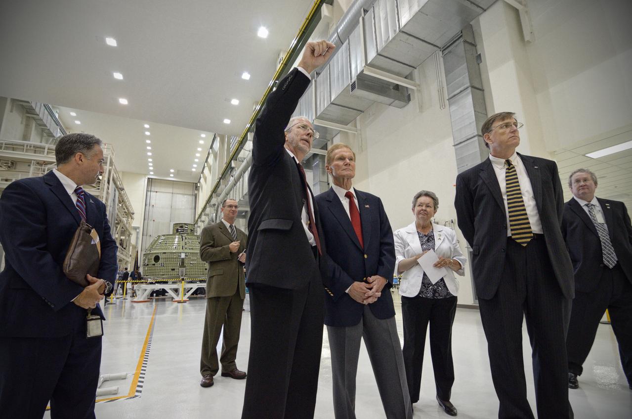 The Orion crew module pressure vessel for Exploration Flight Test-1 (EFT-1) is unveiled at a ceremony at the Operations and Checkout (O&amp;C) Building at NASA’s Kennedy Space Center in Florida on July 2, 2012. Orion Program Manager Mark Geyer is visible talking to others. Part of Batch image transfer from Flickr. 
