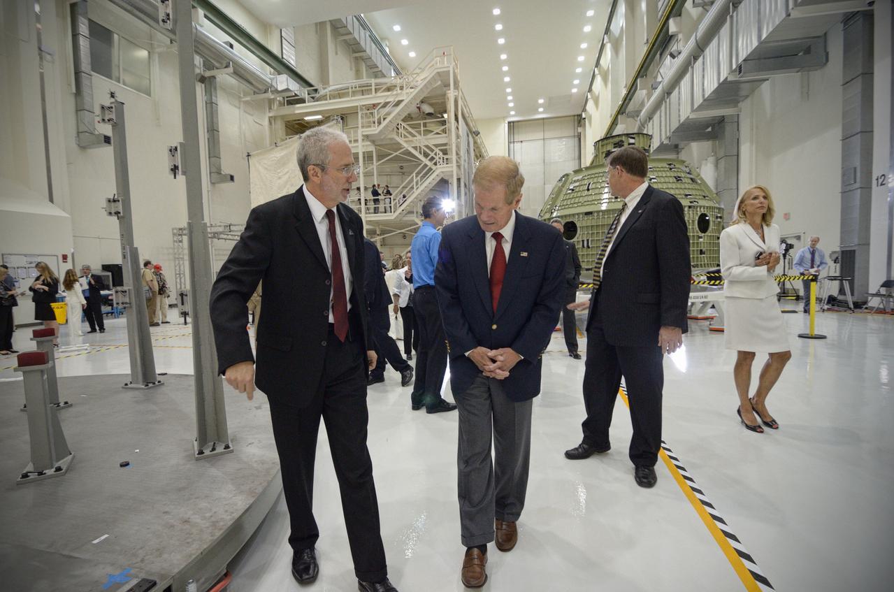 The Orion crew module pressure vessel for Exploration Flight Test-1 (EFT-1) is unveiled at a ceremony at the Operations and Checkout (O&amp;C) Building at NASA’s Kennedy Space Center in Florida on July 2, 2012. Orion Program Manager Mark Geyer is visible talking to others. Part of Batch image transfer from Flickr. 