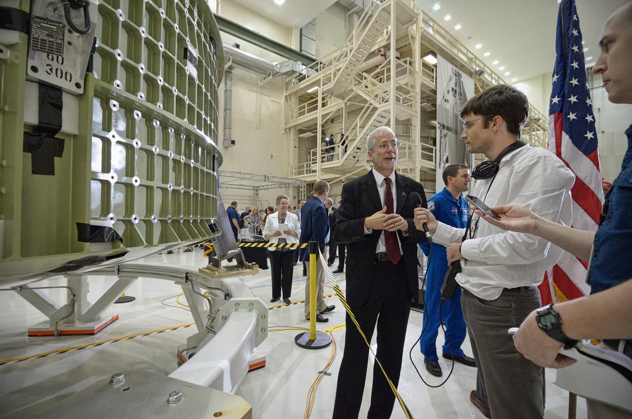 The Orion crew module pressure vessel for Exploration Flight Test-1 (EFT-1) is unveiled at a ceremony at the Operations and Checkout (O&amp;C) Building at NASA’s Kennedy Space Center in Florida on July 2, 2012. Orion Program Manager Mark Geyer is visible talking to others. Part of Batch image transfer from Flickr. 