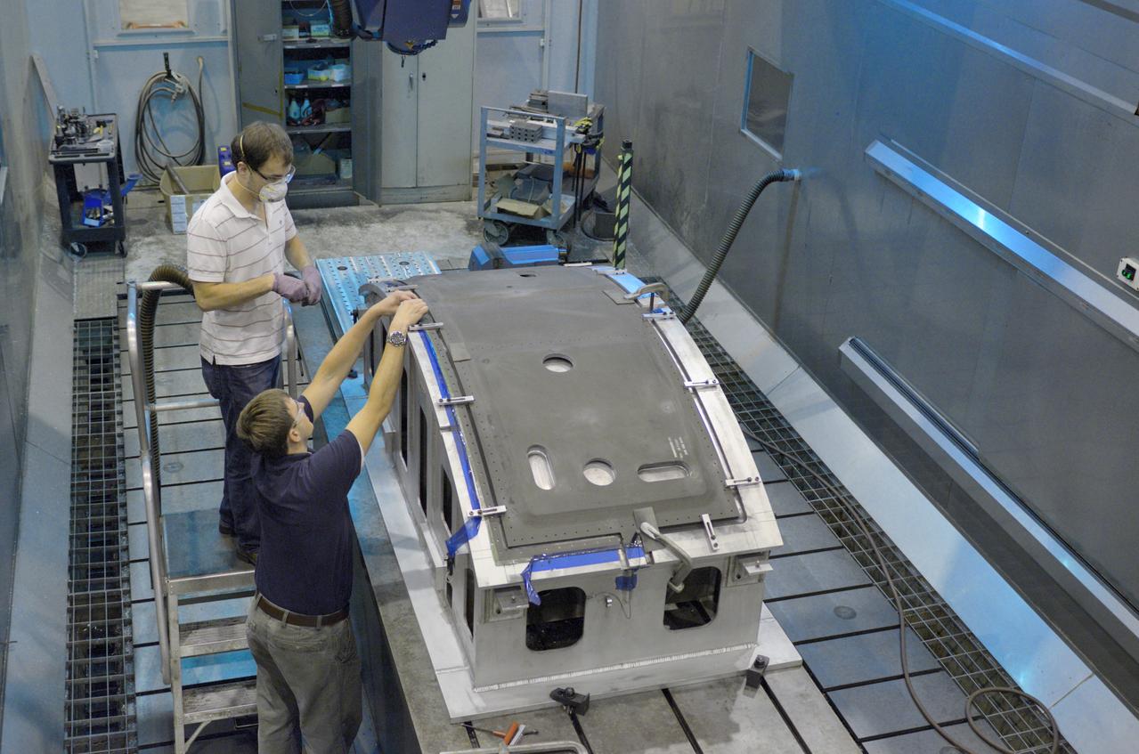 Technicians work on the composite crew module adapter (CMA) panels for the Exploration Flight Test-1 (EFT-1) Orion at NASA's Michoud Assembly Facility in New Orleans on Sept. 25, 2012. Part of Batch image transfer from Flickr.