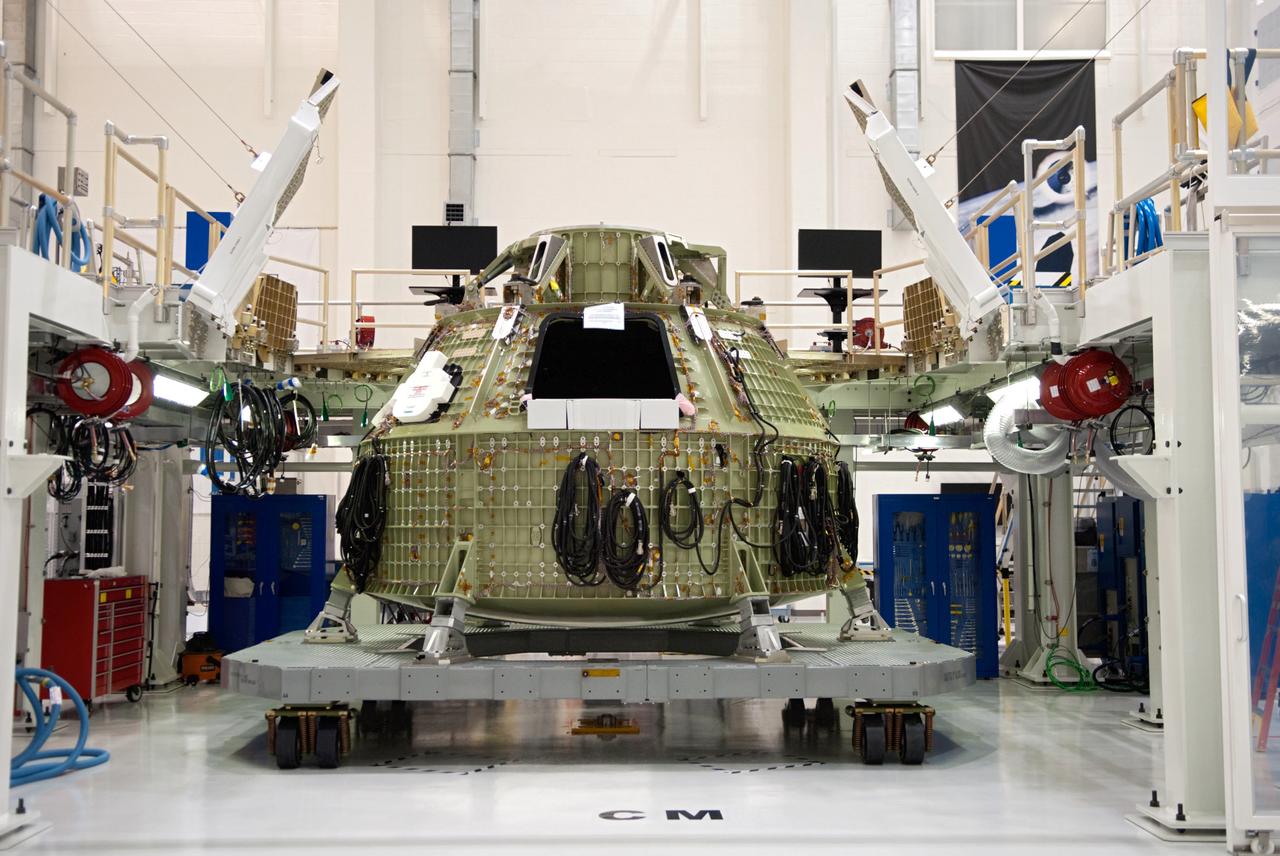 Orion technicians at the Operations and Checkout (O&amp;C) Facility at the Kennedy Space Center move the Orion Exploration Flight Test-1 (EFT-1) crew module from the clean room into the birdcage fixture on Dec. 5, 2012. The fixture is designed to enable precise pre-launch processing of the Orion spacecraft.
