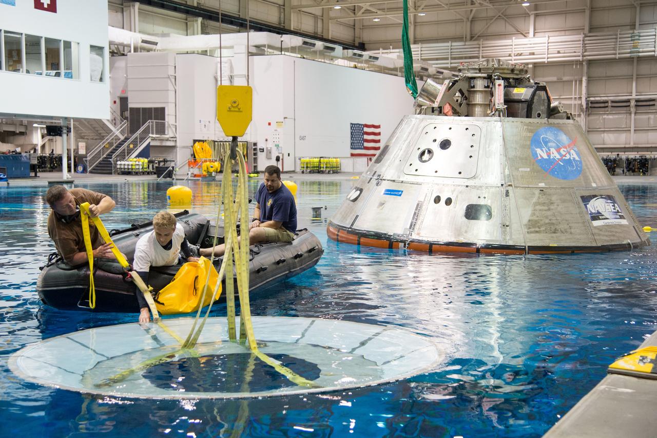 NASA, Department of Defense personnel from Detachment 3 out of Patrick Air Force Base, and the Mobile Diving Salvage Unit based in San Diego conduct a testing session at the Neutral Buoyancy Lab in Houston on Dec. 5, 2012 to evaluate procedures, mockups, and prototype hardware used to train personnel in recovery of the Orion crew module and the forward bay cover for Exploration Flight Test-1 (EFT-1). Part of Batch image transfer from Flickr.