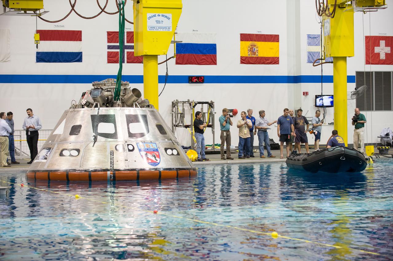 NASA, Department of Defense personnel from Detachment 3 out of Patrick Air Force Base, and the Mobile Diving Salvage Unit based in San Diego conduct a testing session at the Neutral Buoyancy Lab in Houston on Dec. 5, 2012 to evaluate procedures, mockups, and prototype hardware used to train personnel in recovery of the Orion crew module and the forward bay cover for Exploration Flight Test-1 (EFT-1). Part of Batch image transfer from Flickr.