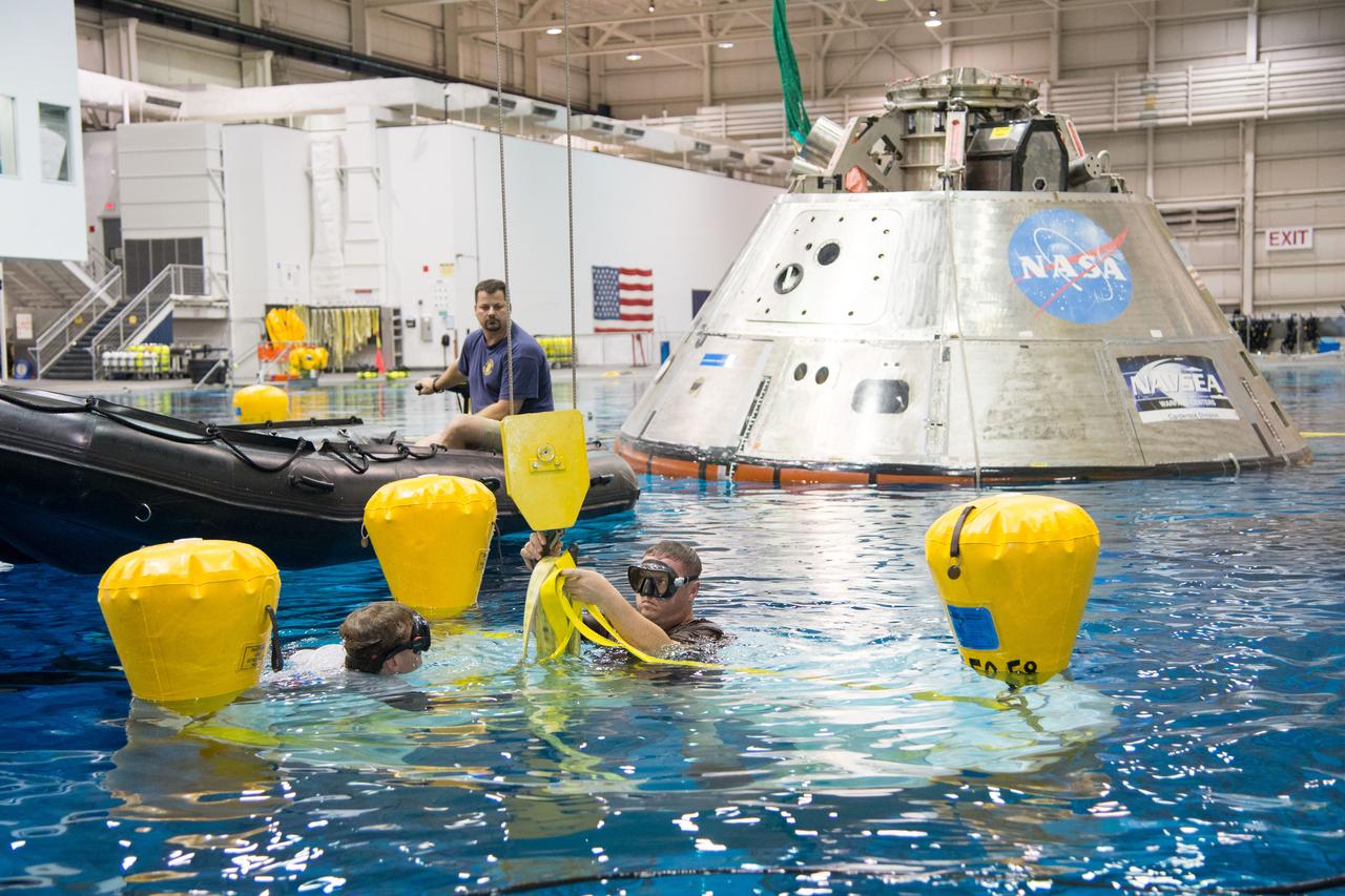 NASA, Department of Defense personnel from Detachment 3 out of Patrick Air Force Base, and the Mobile Diving Salvage Unit based in San Diego conduct a testing session at the Neutral Buoyancy Lab in Houston on Dec. 5, 2012 to evaluate procedures, mockups, and prototype hardware used to train personnel in recovery of the Orion crew module and the forward bay cover for Exploration Flight Test-1 (EFT-1). Part of Batch image transfer from Flickr.