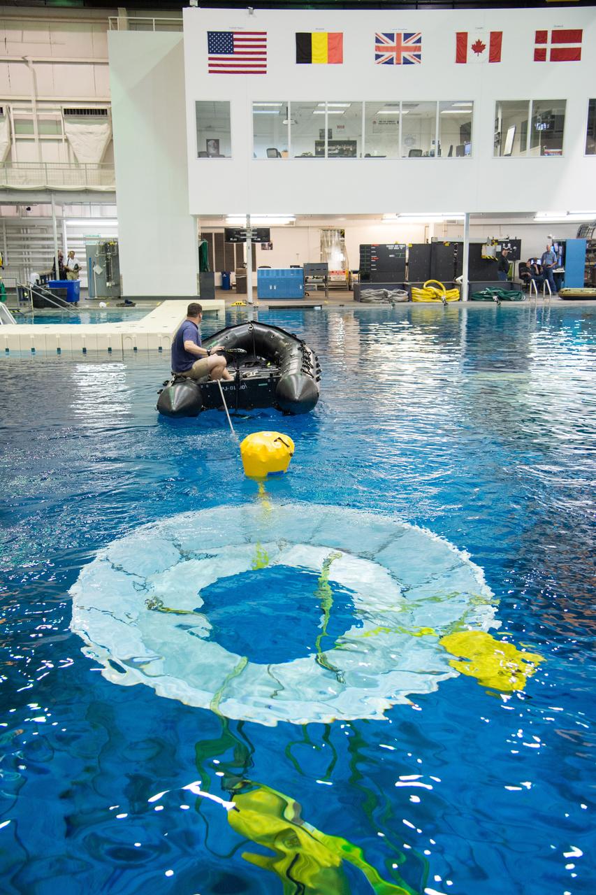 NASA, Department of Defense personnel from Detachment 3 out of Patrick Air Force Base, and the Mobile Diving Salvage Unit based in San Diego conduct a testing session at the Neutral Buoyancy Lab in Houston on Dec. 5, 2012 to evaluate procedures, mockups, and prototype hardware used to train personnel in recovery of the Orion crew module and the forward bay cover for Exploration Flight Test-1 (EFT-1). Part of Batch image transfer from Flickr.