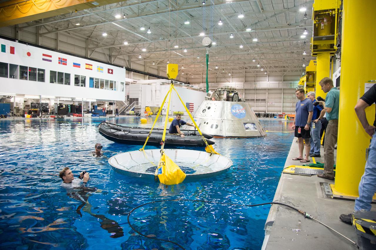 NASA, Department of Defense personnel from Detachment 3 out of Patrick Air Force Base, and the Mobile Diving Salvage Unit based in San Diego conduct a testing session at the Neutral Buoyancy Lab in Houston on Dec. 5, 2012 to evaluate procedures, mockups, and prototype hardware used to train personnel in recovery of the Orion crew module and the forward bay cover for Exploration Flight Test-1 (EFT-1). Part of Batch image transfer from Flickr.