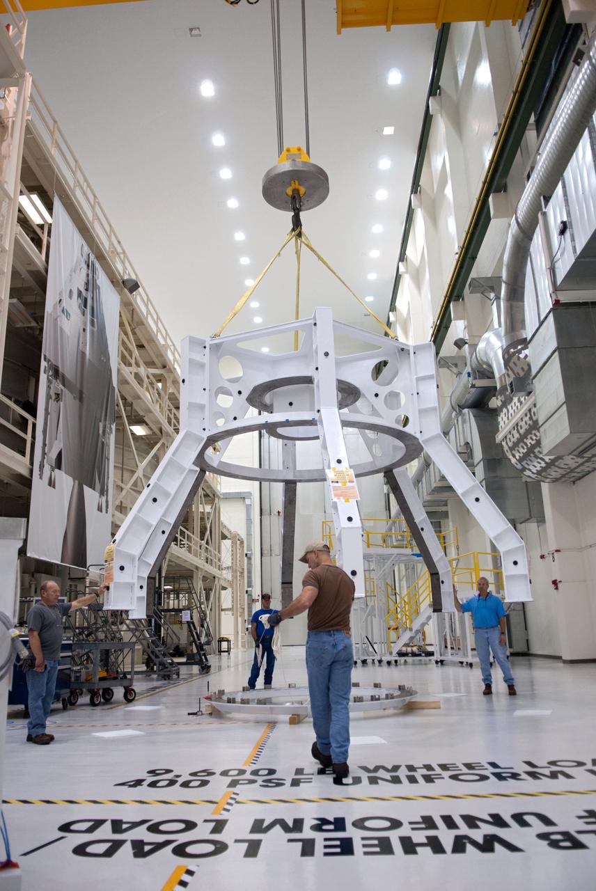 Orion technicians at the Operations and Checkout (O&C) Facility at the Kennedy Space Center move the Orion Exploration Flight Test-1 (EFT-1) crew module from the clean room into the birdcage fixture on Dec. 6, 2012. The fixture is designed to enable precise pre-launch processing of the Orion spacecraft. Part of Batch image transfer from Flickr.