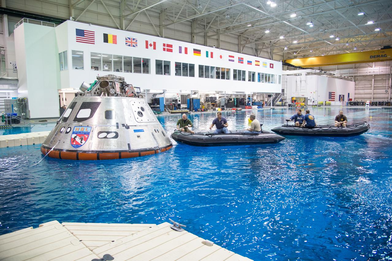 NASA, Department of Defense personnel from Detachment 3 out of Patrick Air Force Base, and the Mobile Diving Salvage Unit based in San Diego conduct a testing session at the Neutral Buoyancy Lab in Houston on Dec. 5, 2012 to evaluate procedures, mockups, and prototype hardware used to train personnel in recovery of the Orion crew module and the forward bay cover for Exploration Flight Test-1 (EFT-1). Part of Batch image transfer from Flickr.