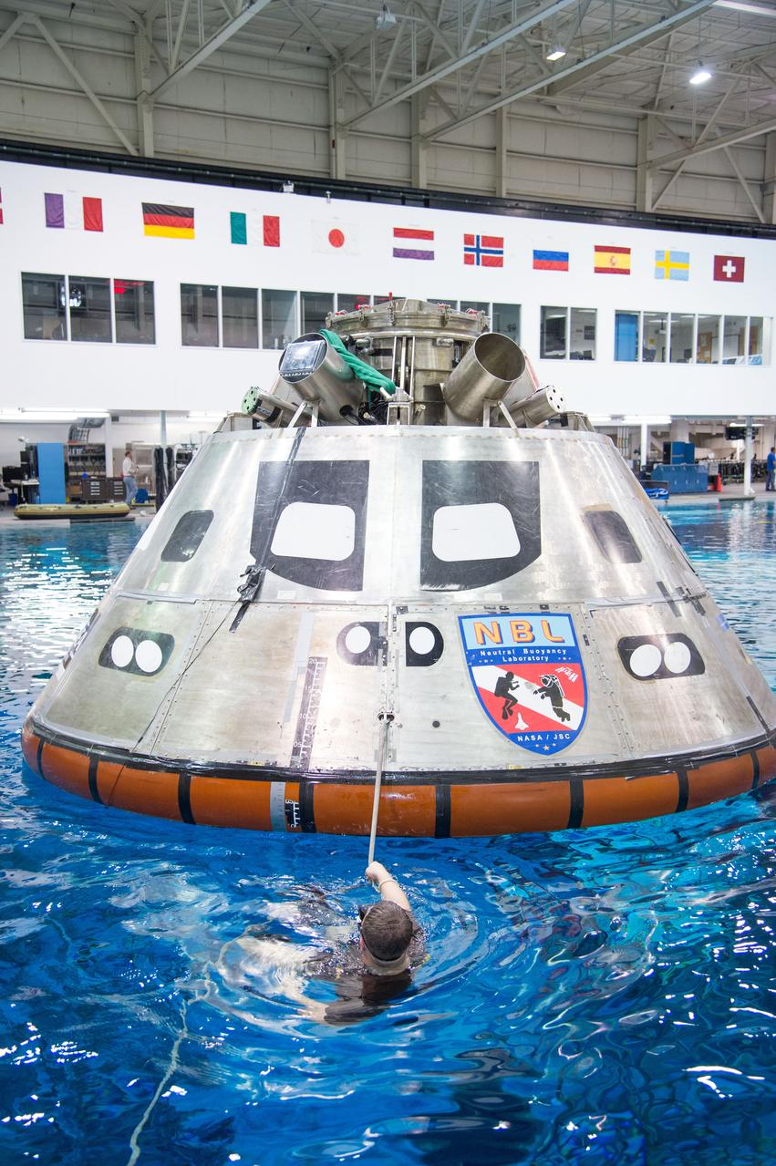 NASA, Department of Defense personnel from Detachment 3 out of Patrick Air Force Base, and the Mobile Diving Salvage Unit based in San Diego conduct a testing session at the Neutral Buoyancy Lab in Houston on Dec. 5, 2012 to evaluate procedures, mockups, and prototype hardware used to train personnel in recovery of the Orion crew module and the forward bay cover for Exploration Flight Test-1 (EFT-1). Part of Batch image transfer from Flickr.