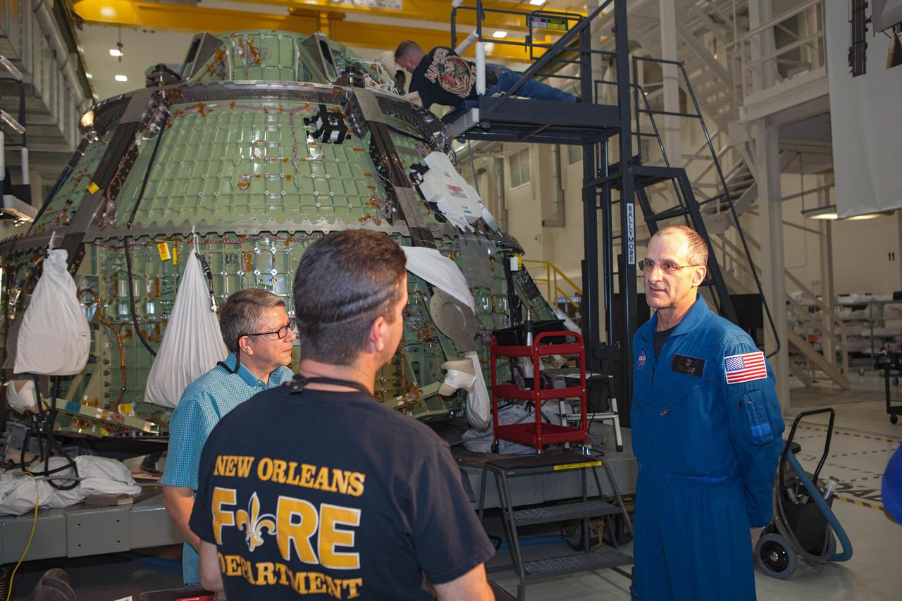 Work continues on the Exploration Flight Test-1 (EFT-1) Orion crew module in the Operations and Checkout Building (O&C) at Kennedy Space Center on March 21, 2013. Astronaut Don Pettit is visible talking to workmen. Part of Batch image transfer from Flickr.
