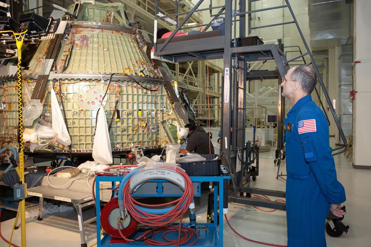 Work continues on the Exploration Flight Test-1 (EFT-1) Orion crew module in the Operations and Checkout Building (O&C) at Kennedy Space Center on March 21, 2013. Astronaut Don Pettit is visible talking to workmen. Part of Batch image transfer from Flickr.