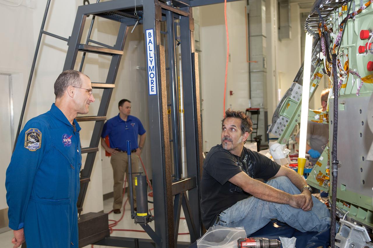 Work continues on the Exploration Flight Test-1 (EFT-1) Orion crew module in the Operations and Checkout Building (O&C) at Kennedy Space Center on March 21, 2013. Astronaut Don Pettit is visible talking to workmen. Part of Batch image transfer from Flickr.