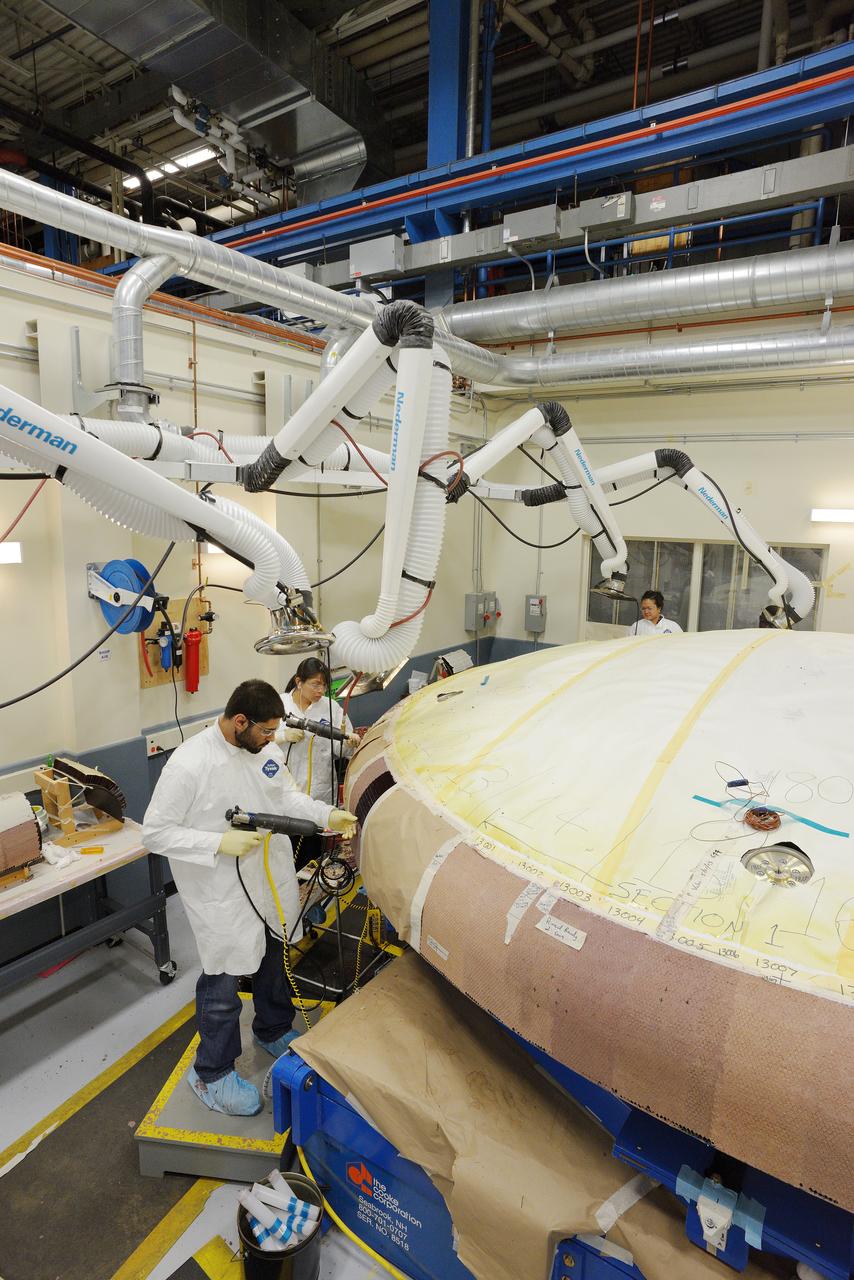 Technicians at Textron in Wimington, MA, apply Avcoat ablative material to the composite honeycomb structure attached to the Exploration Flight Test-1 (EFT-1) Orion heat shield carrier structure on May 22, 2013. Part of Batch image transfer from Flickr.