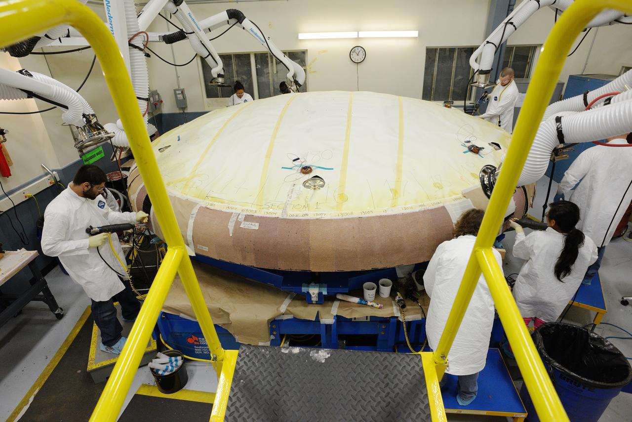 Technicians at Textron in Wimington, MA, apply Avcoat ablative material to the composite honeycomb structure attached to the Exploration Flight Test-1 (EFT-1) Orion heat shield carrier structure on May 22, 2013. Part of Batch image transfer from Flickr.