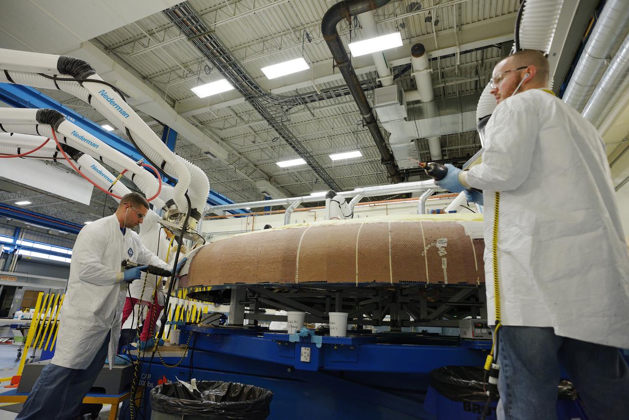 Technicians at Textron in Wimington, MA, apply Avcoat ablative material to the composite honeycomb structure attached to the Exploration Flight Test-1 (EFT-1) Orion heat shield carrier structure on May 22, 2013. Part of Batch image transfer from Flickr.