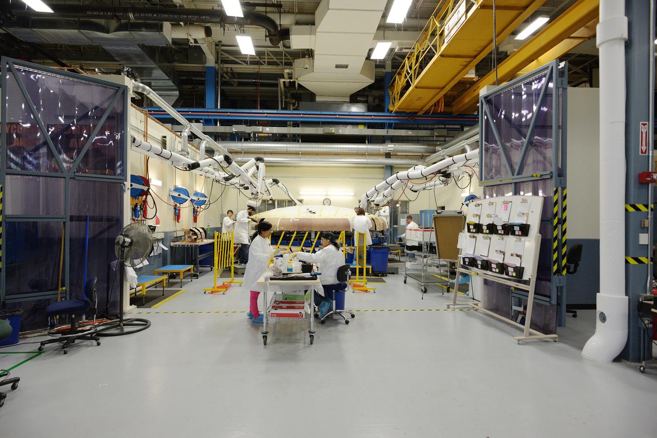 Technicians at Textron in Wimington, MA, apply Avcoat ablative material to the composite honeycomb structure attached to the Exploration Flight Test-1 (EFT-1) Orion heat shield carrier structure on May 22, 2013. Part of Batch image transfer from Flickr.