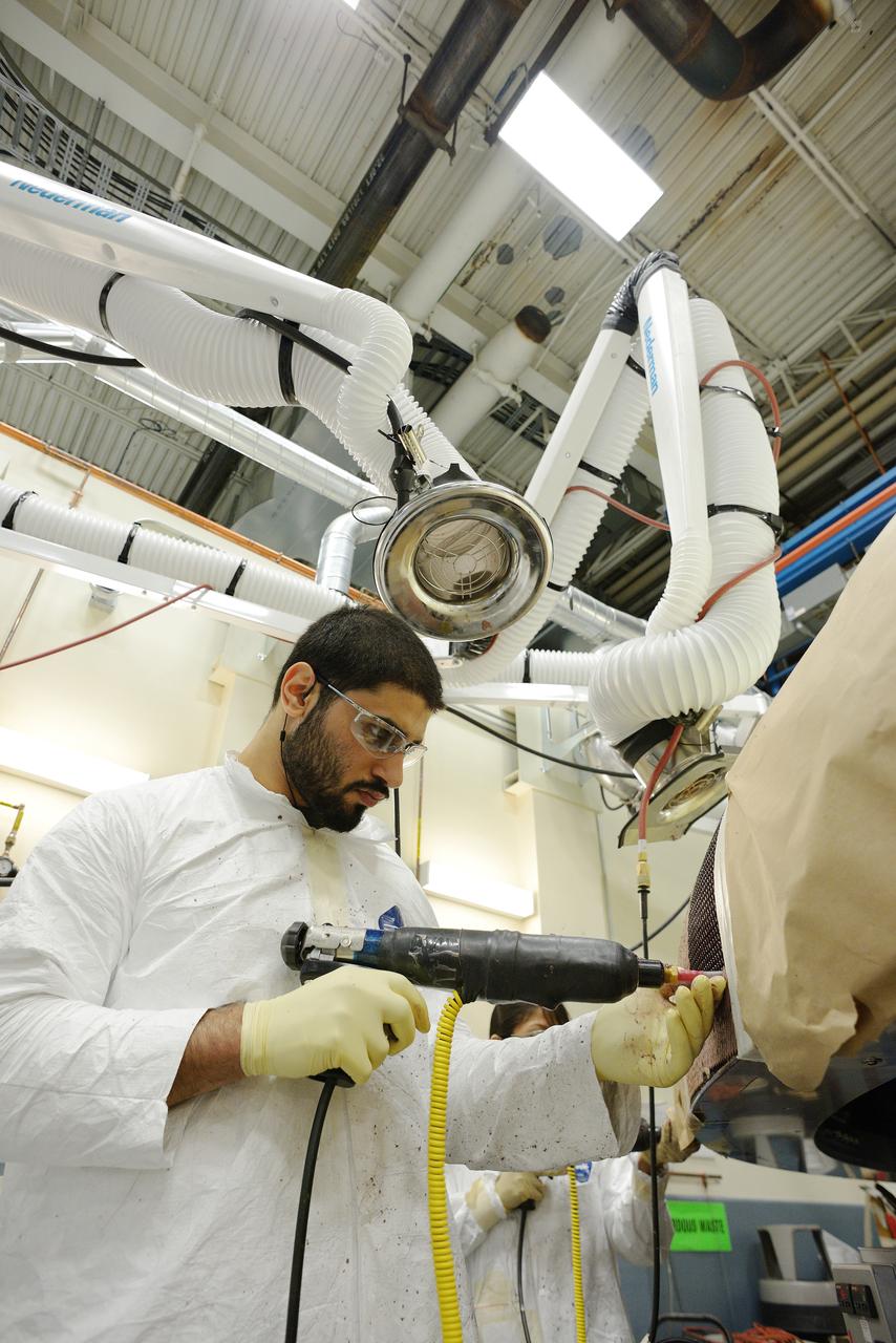 Technicians at Textron in Wimington, MA, apply Avcoat ablative material to the composite honeycomb structure attached to the Exploration Flight Test-1 (EFT-1) Orion heat shield carrier structure on May 22, 2013. Part of Batch image transfer from Flickr.