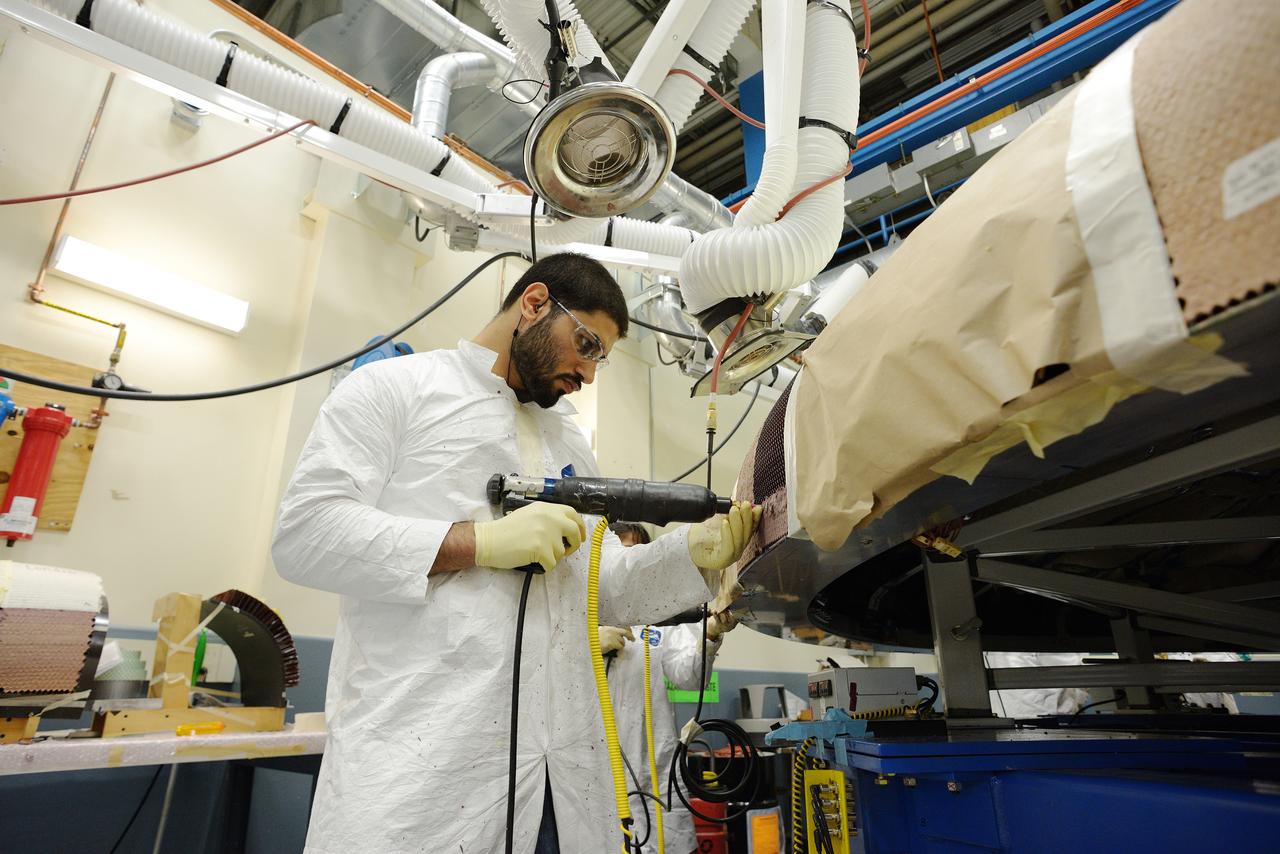 Technicians at Textron in Wimington, MA, apply Avcoat ablative material to the composite honeycomb structure attached to the Exploration Flight Test-1 (EFT-1) Orion heat shield carrier structure on May 22, 2013. Part of Batch image transfer from Flickr.