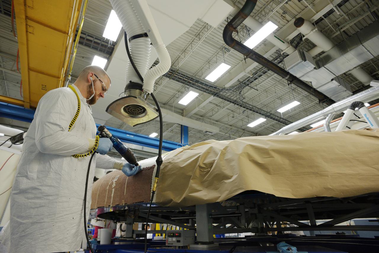 Technicians at Textron in Wimington, MA, apply Avcoat ablative material to the composite honeycomb structure attached to the Exploration Flight Test-1 (EFT-1) Orion heat shield carrier structure on May 22, 2013. Part of Batch image transfer from Flickr.