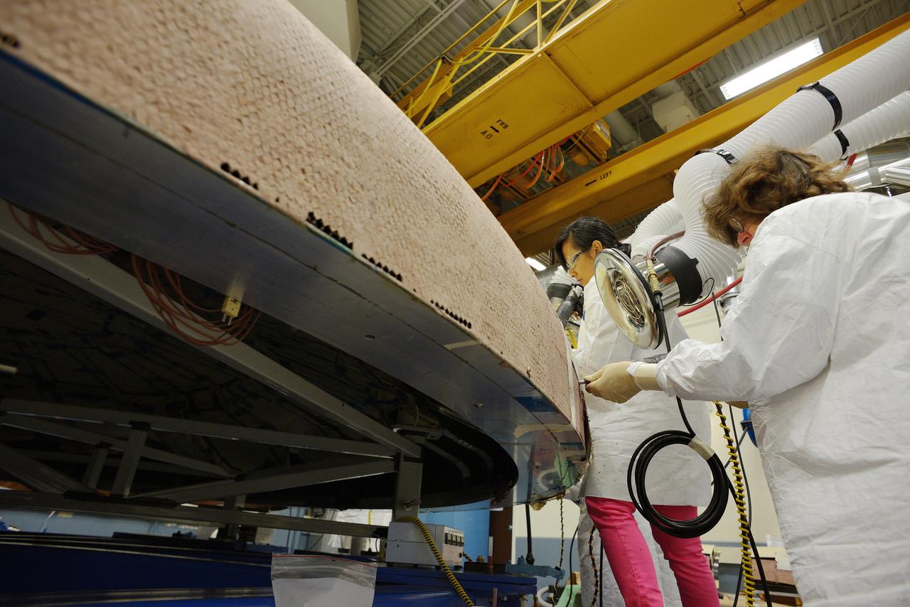 Technicians at Textron in Wimington, MA, apply Avcoat ablative material to the composite honeycomb structure attached to the Exploration Flight Test-1 (EFT-1) Orion heat shield carrier structure on May 22, 2013. Part of Batch image transfer from Flickr.