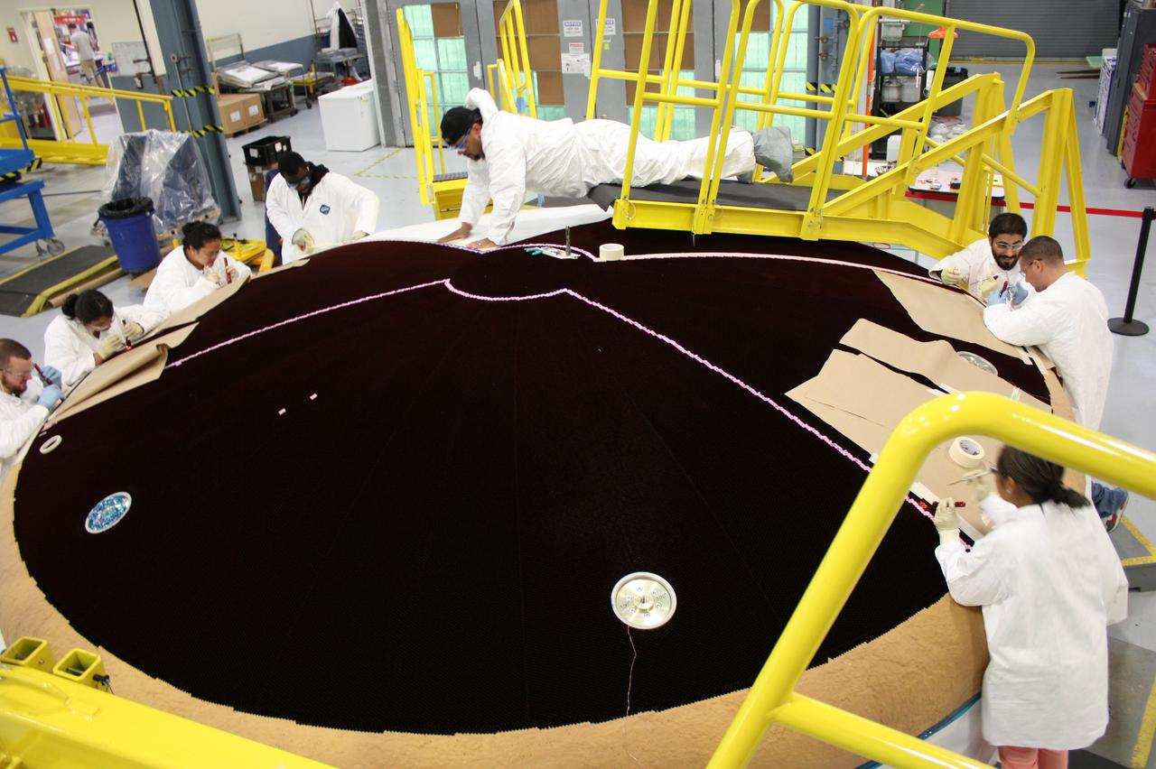 Technicians work on the Exploration Flight Test-1 (EFT-1) Orion heat shield at Textron in Wimington, MA on June 7, 2013. Part of Batch image transfer from Flickr.