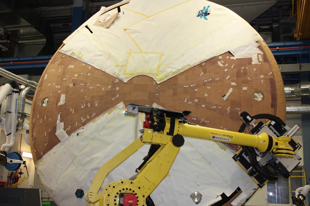 Technicians work on the Exploration Flight Test-1 (EFT-1) Orion heat shield at Textron in Wimington, MA on June 7, 2013. Part of Batch image transfer from Flickr.