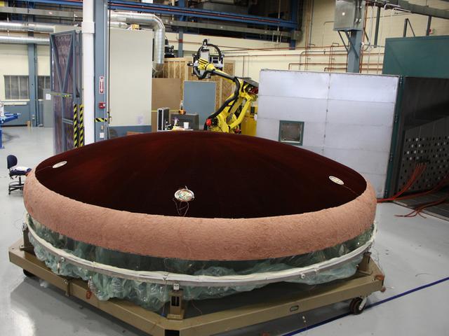 Technicians work on the Exploration Flight Test-1 (EFT-1) Orion heat shield at Textron in Wimington, MA on June 7, 2013. Part of Batch image transfer from Flickr.