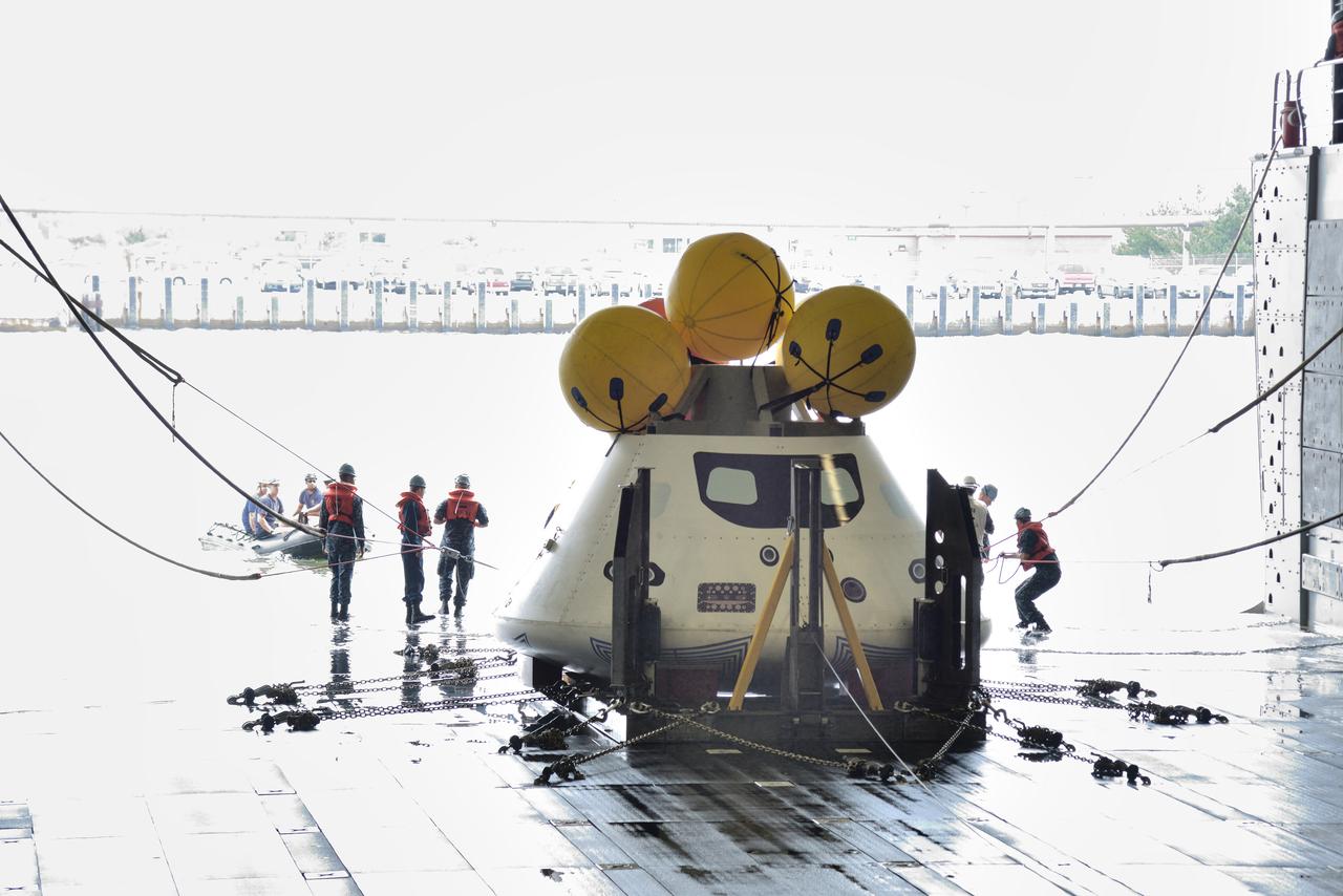 The Orion test capsule undergoes stationary recovery testing in Norfolk, VA on Aug. 13, 2013. NASA and the U.S Navy led the tests using the USS Arlington...The stationary recovery tests allow the teams to demonstrate and evaluate the recovery processes, the hardware and the test personnel in a controlled environment. ..During the test, the U.S Navy Dive Team checked the capsule for hazards while sailors from the USS Arlington approached the capsule in inflatable boats, and towed it back to the ship’s flooded well deck.  Part of Batch image transfer from Flickr.