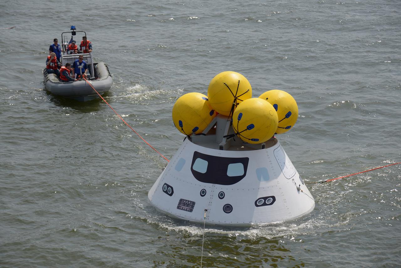The Orion test capsule undergoes stationary recovery testing in Norfolk, VA on Aug. 13, 2013. NASA and the U.S Navy led the tests using the USS Arlington...The stationary recovery tests allow the teams to demonstrate and evaluate the recovery processes, the hardware and the test personnel in a controlled environment. ..During the test, the U.S Navy Dive Team checked the capsule for hazards while sailors from the USS Arlington approached the capsule in inflatable boats, and towed it back to the ship’s flooded well deck.  Part of Batch image transfer from Flickr.