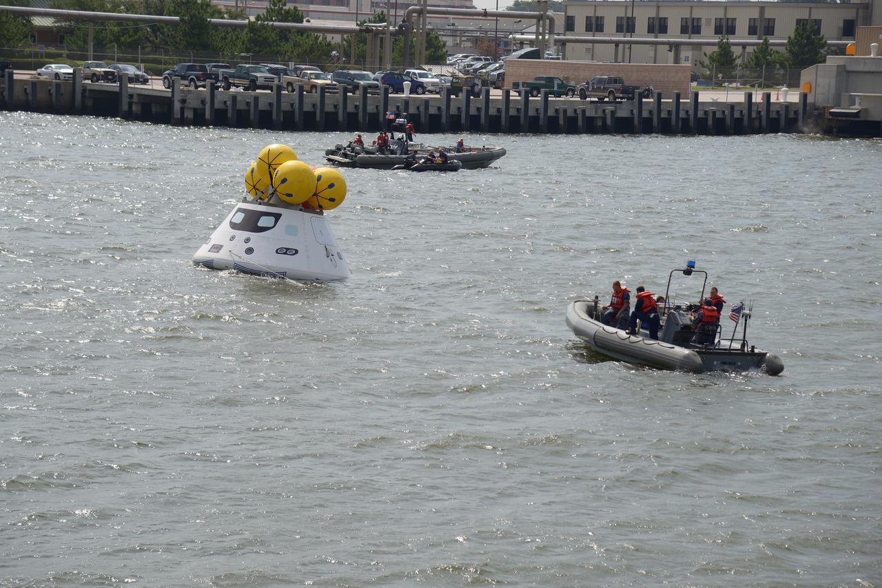 The Orion test capsule undergoes stationary recovery testing in Norfolk, VA on Aug. 13, 2013. NASA and the U.S Navy led the tests using the USS Arlington...The stationary recovery tests allow the teams to demonstrate and evaluate the recovery processes, the hardware and the test personnel in a controlled environment. ..During the test, the U.S Navy Dive Team checked the capsule for hazards while sailors from the USS Arlington approached the capsule in inflatable boats, and towed it back to the ship’s flooded well deck.  Part of Batch image transfer from Flickr.
