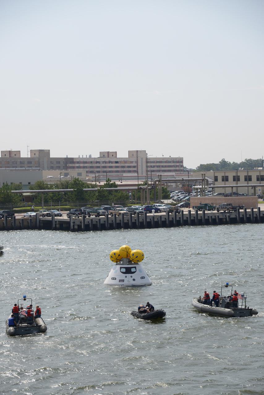 The Orion test capsule undergoes stationary recovery testing in Norfolk, VA on Aug. 13, 2013. NASA and the U.S Navy led the tests using the USS Arlington...The stationary recovery tests allow the teams to demonstrate and evaluate the recovery processes, the hardware and the test personnel in a controlled environment. ..During the test, the U.S Navy Dive Team checked the capsule for hazards while sailors from the USS Arlington approached the capsule in inflatable boats, and towed it back to the ship’s flooded well deck.  Part of Batch image transfer from Flickr.