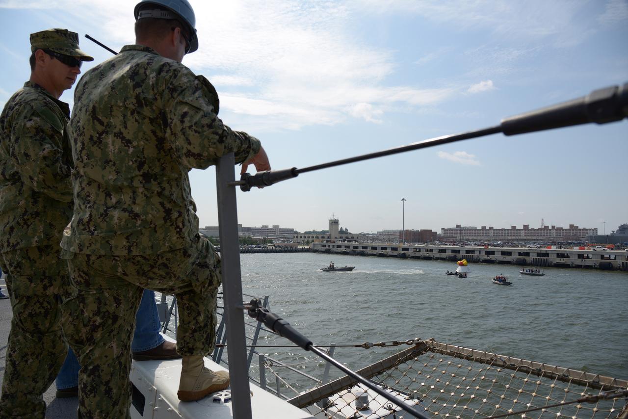 The Orion test capsule undergoes stationary recovery testing in Norfolk, VA on Aug. 13, 2013. NASA and the U.S Navy led the tests using the USS Arlington...The stationary recovery tests allow the teams to demonstrate and evaluate the recovery processes, the hardware and the test personnel in a controlled environment. ..During the test, the U.S Navy Dive Team checked the capsule for hazards while sailors from the USS Arlington approached the capsule in inflatable boats, and towed it back to the ship’s flooded well deck.  Part of Batch image transfer from Flickr.