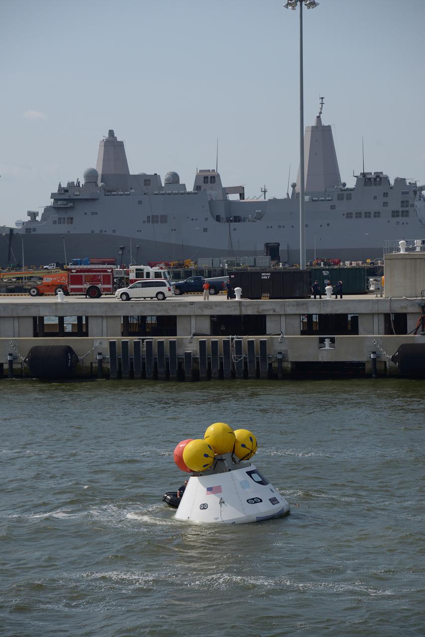 The Orion test capsule undergoes stationary recovery testing in Norfolk, VA on Aug. 13, 2013. NASA and the U.S Navy led the tests using the USS Arlington...The stationary recovery tests allow the teams to demonstrate and evaluate the recovery processes, the hardware and the test personnel in a controlled environment. ..During the test, the U.S Navy Dive Team checked the capsule for hazards while sailors from the USS Arlington approached the capsule in inflatable boats, and towed it back to the ship’s flooded well deck.  Part of Batch image transfer from Flickr.