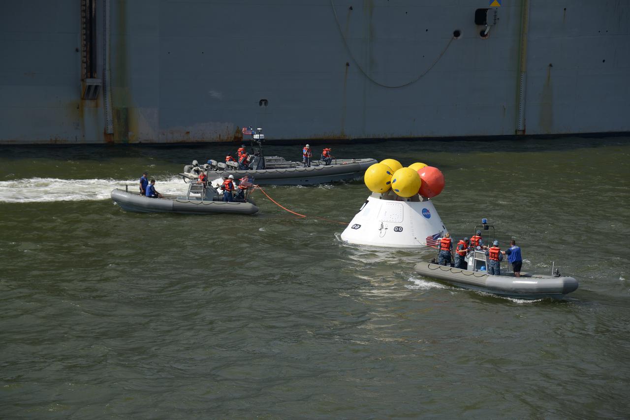 The Orion test capsule undergoes stationary recovery testing in Norfolk, VA on Aug. 13, 2013. NASA and the U.S Navy led the tests using the USS Arlington...The stationary recovery tests allow the teams to demonstrate and evaluate the recovery processes, the hardware and the test personnel in a controlled environment. ..During the test, the U.S Navy Dive Team checked the capsule for hazards while sailors from the USS Arlington approached the capsule in inflatable boats, and towed it back to the ship’s flooded well deck.  Part of Batch image transfer from Flickr.
