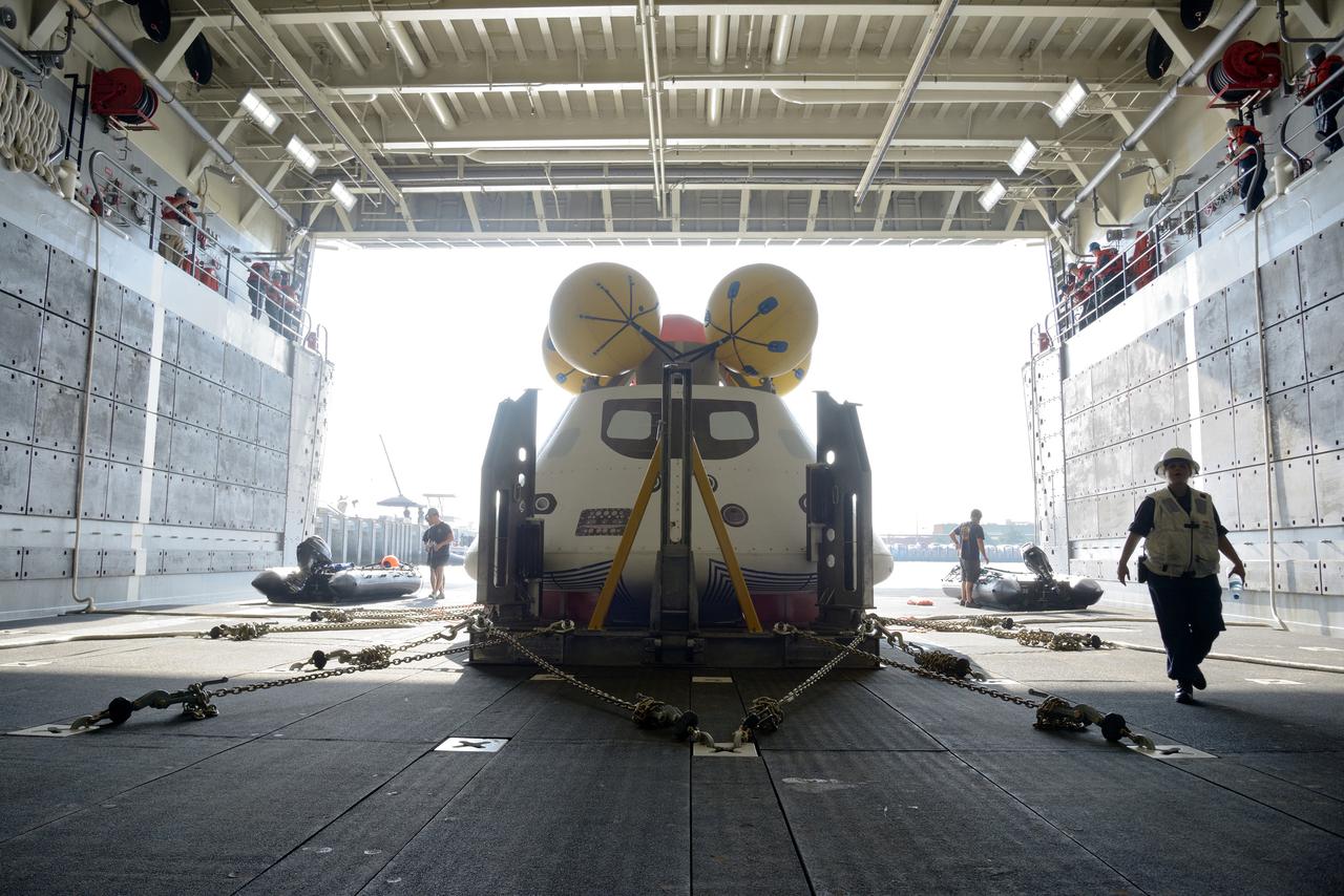 The Orion test capsule undergoes stationary recovery testing in Norfolk, VA on Aug. 13, 2013. NASA and the U.S Navy led the tests using the USS Arlington...The stationary recovery tests allow the teams to demonstrate and evaluate the recovery processes, the hardware and the test personnel in a controlled environment. ..During the test, the U.S Navy Dive Team checked the capsule for hazards while sailors from the USS Arlington approached the capsule in inflatable boats, and towed it back to the ship’s flooded well deck.  Part of Batch image transfer from Flickr.