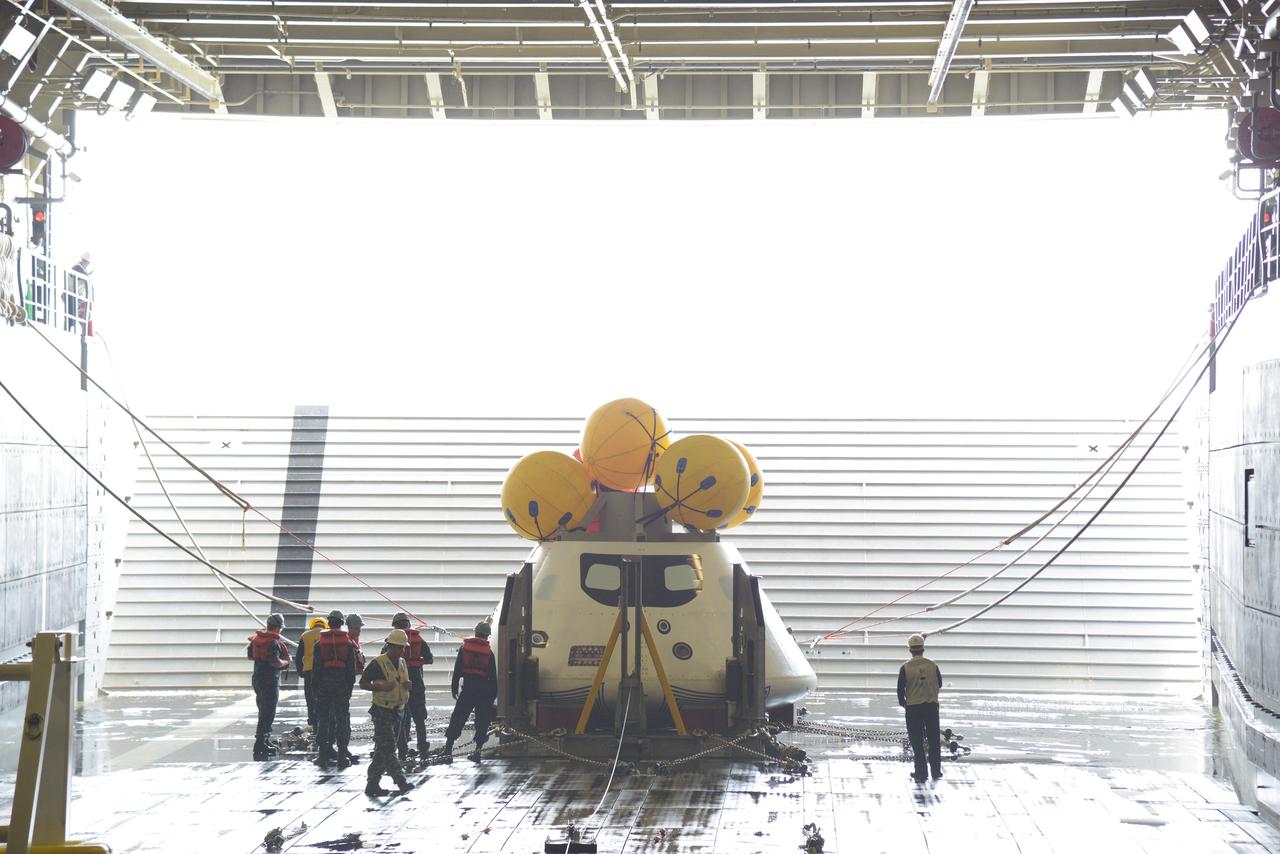 The Orion test capsule undergoes stationary recovery testing in Norfolk, VA on Aug. 13, 2013. NASA and the U.S Navy led the tests using the USS Arlington...The stationary recovery tests allow the teams to demonstrate and evaluate the recovery processes, the hardware and the test personnel in a controlled environment. ..During the test, the U.S Navy Dive Team checked the capsule for hazards while sailors from the USS Arlington approached the capsule in inflatable boats, and towed it back to the ship’s flooded well deck.  Part of Batch image transfer from Flickr.