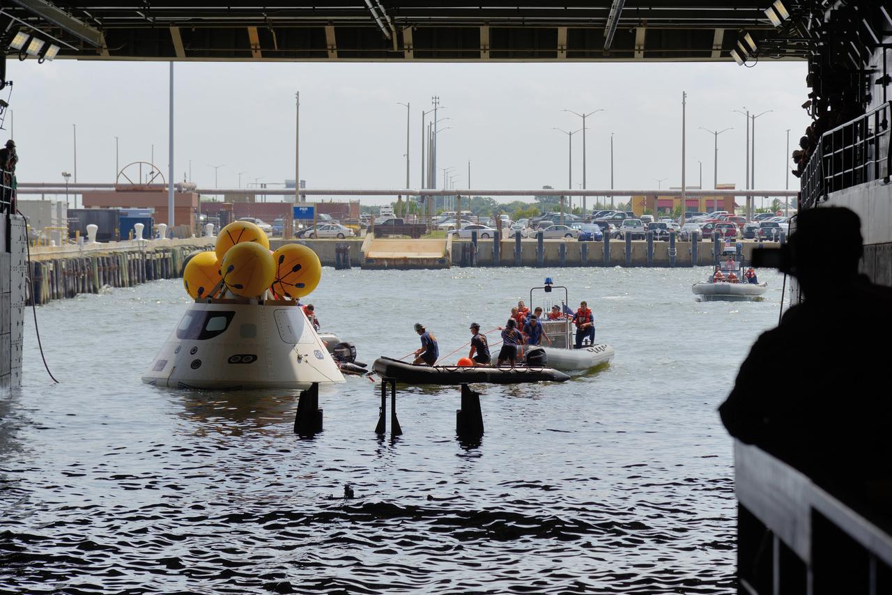 The Orion test capsule undergoes stationary recovery testing in Norfolk, VA on Aug. 13, 2013. NASA and the U.S Navy led the tests using the USS Arlington...The stationary recovery tests allow the teams to demonstrate and evaluate the recovery processes, the hardware and the test personnel in a controlled environment. ..During the test, the U.S Navy Dive Team checked the capsule for hazards while sailors from the USS Arlington approached the capsule in inflatable boats, and towed it back to the ship’s flooded well deck.  Part of Batch image transfer from Flickr.