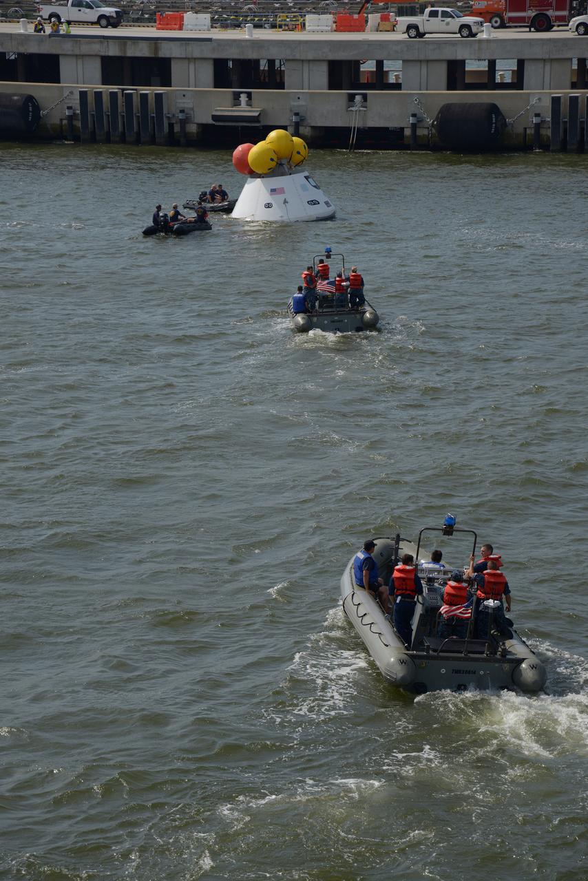 The Orion test capsule undergoes stationary recovery testing in Norfolk, VA on Aug. 13, 2013. NASA and the U.S Navy led the tests using the USS Arlington...The stationary recovery tests allow the teams to demonstrate and evaluate the recovery processes, the hardware and the test personnel in a controlled environment. ..During the test, the U.S Navy Dive Team checked the capsule for hazards while sailors from the USS Arlington approached the capsule in inflatable boats, and towed it back to the ship’s flooded well deck.  Part of Batch image transfer from Flickr.