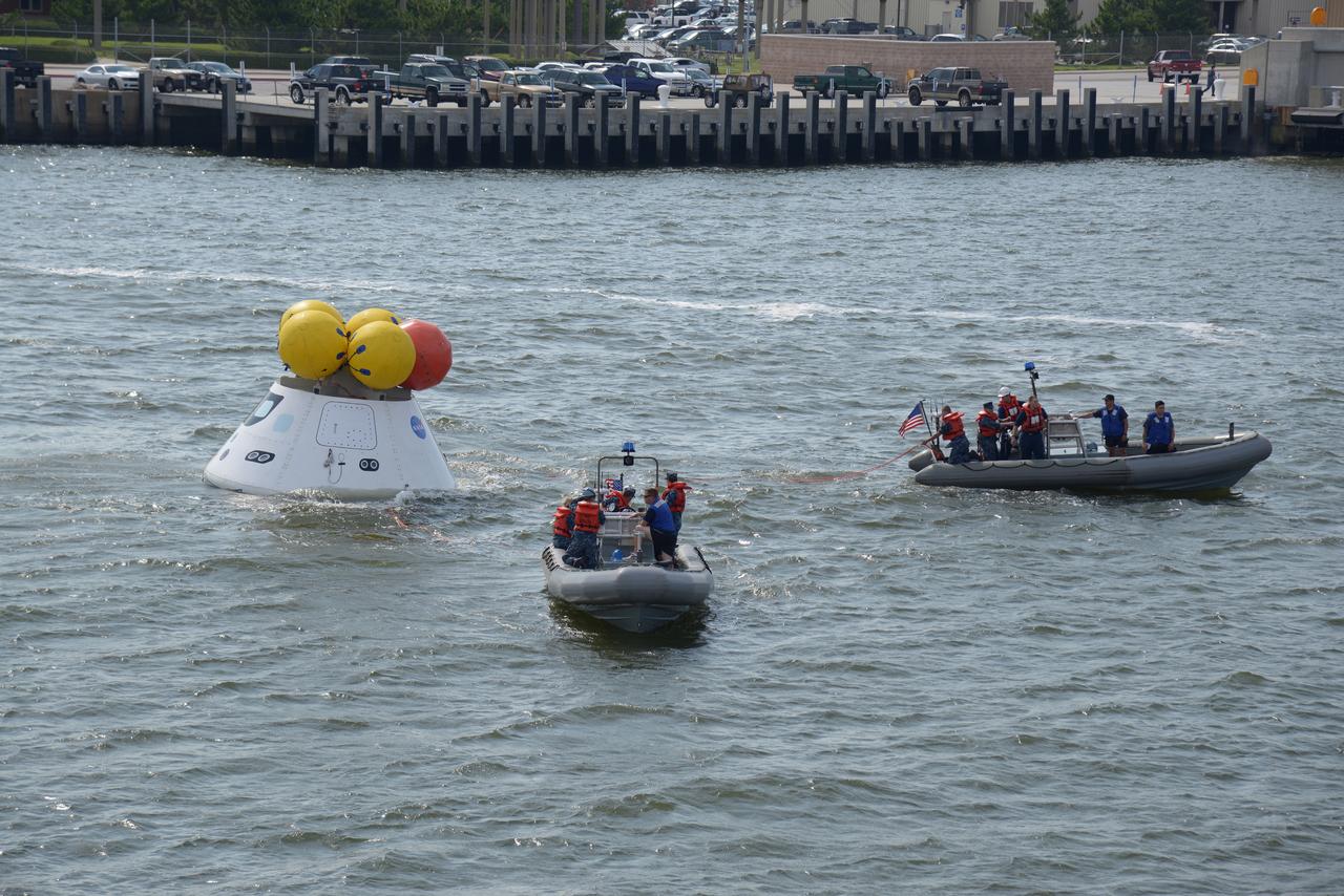 The Orion test capsule undergoes stationary recovery testing in Norfolk, VA on Aug. 13, 2013. NASA and the U.S Navy led the tests using the USS Arlington...The stationary recovery tests allow the teams to demonstrate and evaluate the recovery processes, the hardware and the test personnel in a controlled environment. ..During the test, the U.S Navy Dive Team checked the capsule for hazards while sailors from the USS Arlington approached the capsule in inflatable boats, and towed it back to the ship’s flooded well deck.  Part of Batch image transfer from Flickr.