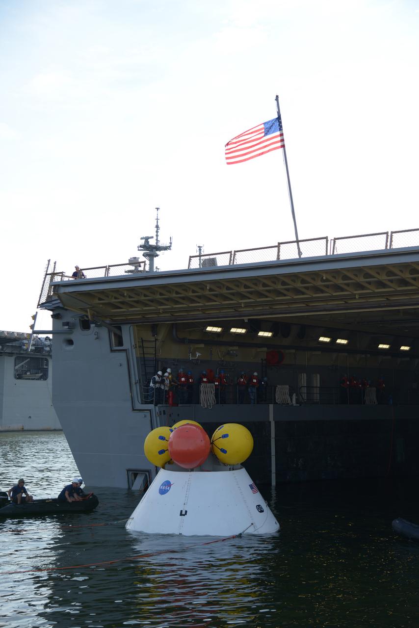 The Orion test capsule undergoes stationary recovery testing in Norfolk, VA on Aug. 13, 2013. NASA and the U.S Navy led the tests using the USS Arlington...The stationary recovery tests allow the teams to demonstrate and evaluate the recovery processes, the hardware and the test personnel in a controlled environment. ..During the test, the U.S Navy Dive Team checked the capsule for hazards while sailors from the USS Arlington approached the capsule in inflatable boats, and towed it back to the ship’s flooded well deck.  Part of Batch image transfer from Flickr.