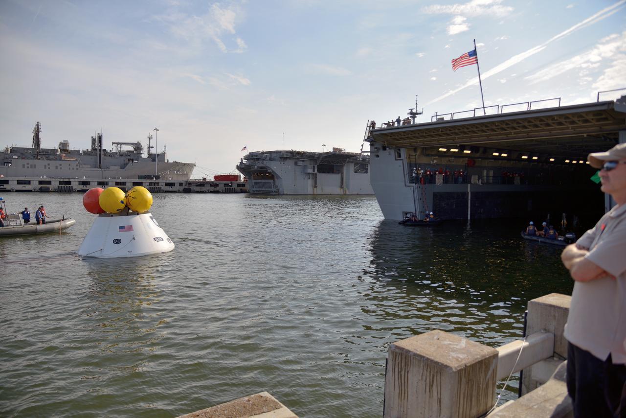 The Orion test capsule undergoes stationary recovery testing in Norfolk, VA on Aug. 13, 2013. NASA and the U.S Navy led the tests using the USS Arlington...The stationary recovery tests allow the teams to demonstrate and evaluate the recovery processes, the hardware and the test personnel in a controlled environment. ..During the test, the U.S Navy Dive Team checked the capsule for hazards while sailors from the USS Arlington approached the capsule in inflatable boats, and towed it back to the ship’s flooded well deck.  Part of Batch image transfer from Flickr.