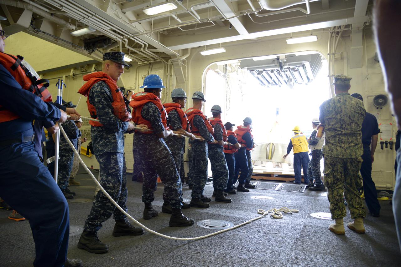 The Orion test capsule undergoes stationary recovery testing in Norfolk, VA on Aug. 13, 2013. NASA and the U.S Navy led the tests using the USS Arlington...The stationary recovery tests allow the teams to demonstrate and evaluate the recovery processes, the hardware and the test personnel in a controlled environment. ..During the test, the U.S Navy Dive Team checked the capsule for hazards while sailors from the USS Arlington approached the capsule in inflatable boats, and towed it back to the ship’s flooded well deck.  Part of Batch image transfer from Flickr.