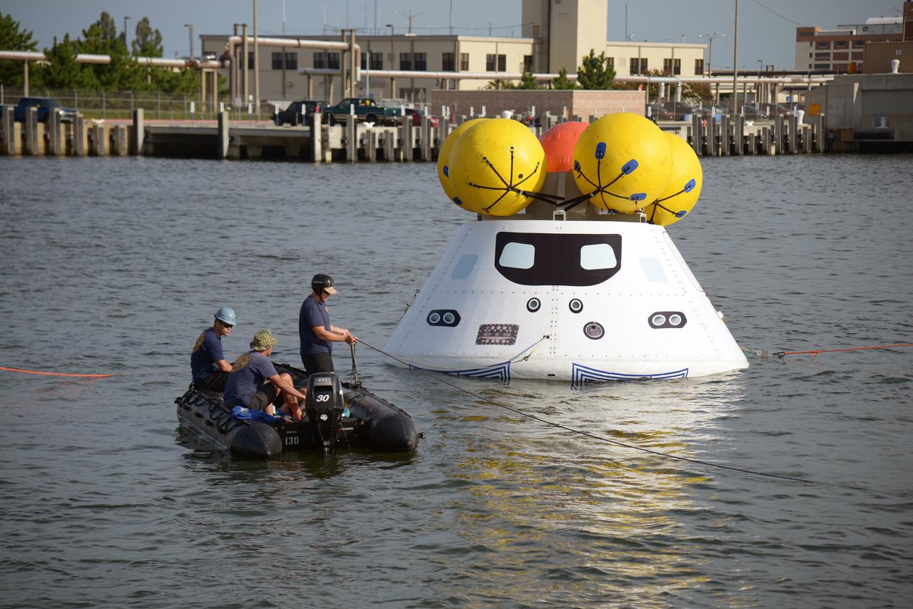 The Orion test capsule undergoes stationary recovery testing in Norfolk, VA on Aug. 13, 2013. NASA and the U.S Navy led the tests using the USS Arlington...The stationary recovery tests allow the teams to demonstrate and evaluate the recovery processes, the hardware and the test personnel in a controlled environment. ..During the test, the U.S Navy Dive Team checked the capsule for hazards while sailors from the USS Arlington approached the capsule in inflatable boats, and towed it back to the ship’s flooded well deck.  Part of Batch image transfer from Flickr.