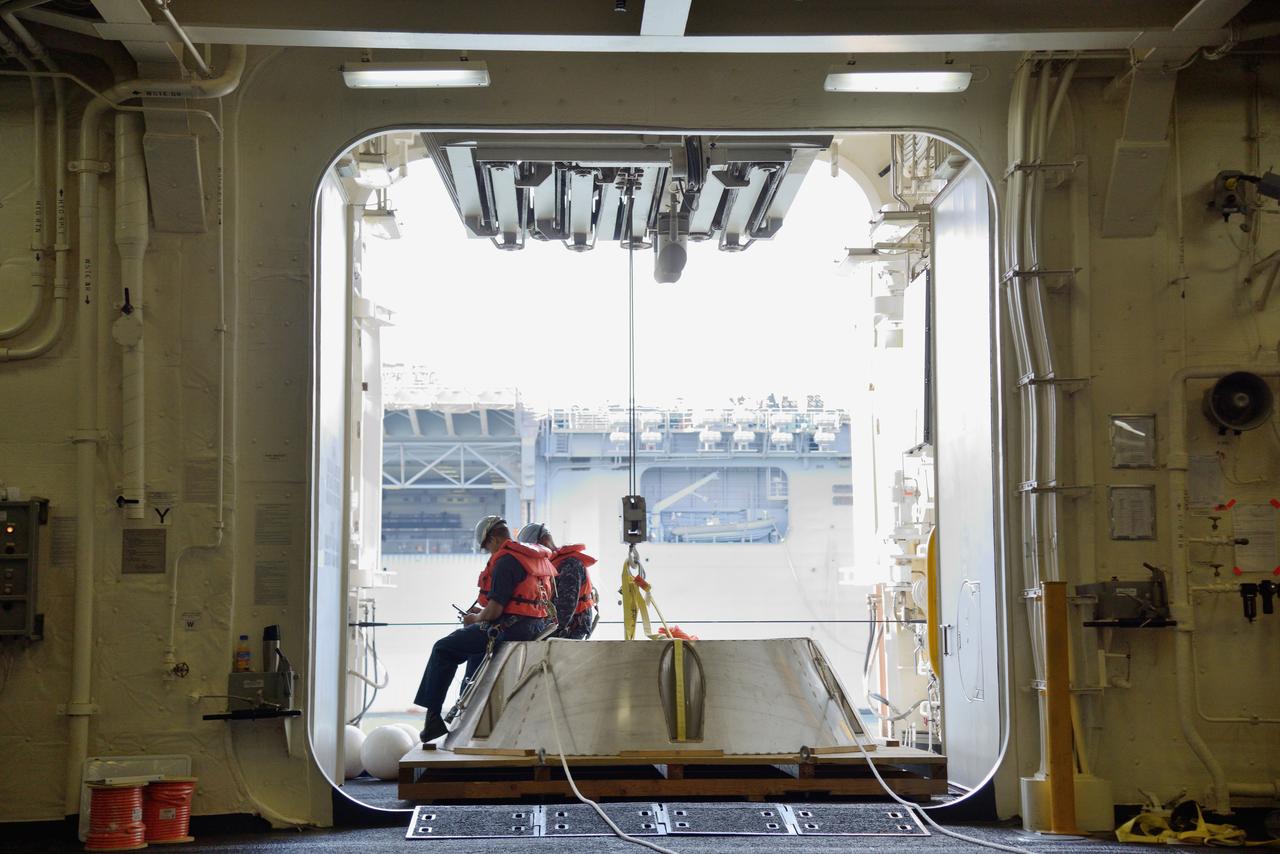 The Orion test capsule undergoes stationary recovery testing in Norfolk, VA on Aug. 13, 2013. NASA and the U.S Navy led the tests using the USS Arlington...The stationary recovery tests allow the teams to demonstrate and evaluate the recovery processes, the hardware and the test personnel in a controlled environment. ..During the test, the U.S Navy Dive Team checked the capsule for hazards while sailors from the USS Arlington approached the capsule in inflatable boats, and towed it back to the ship’s flooded well deck.  Part of Batch image transfer from Flickr.
