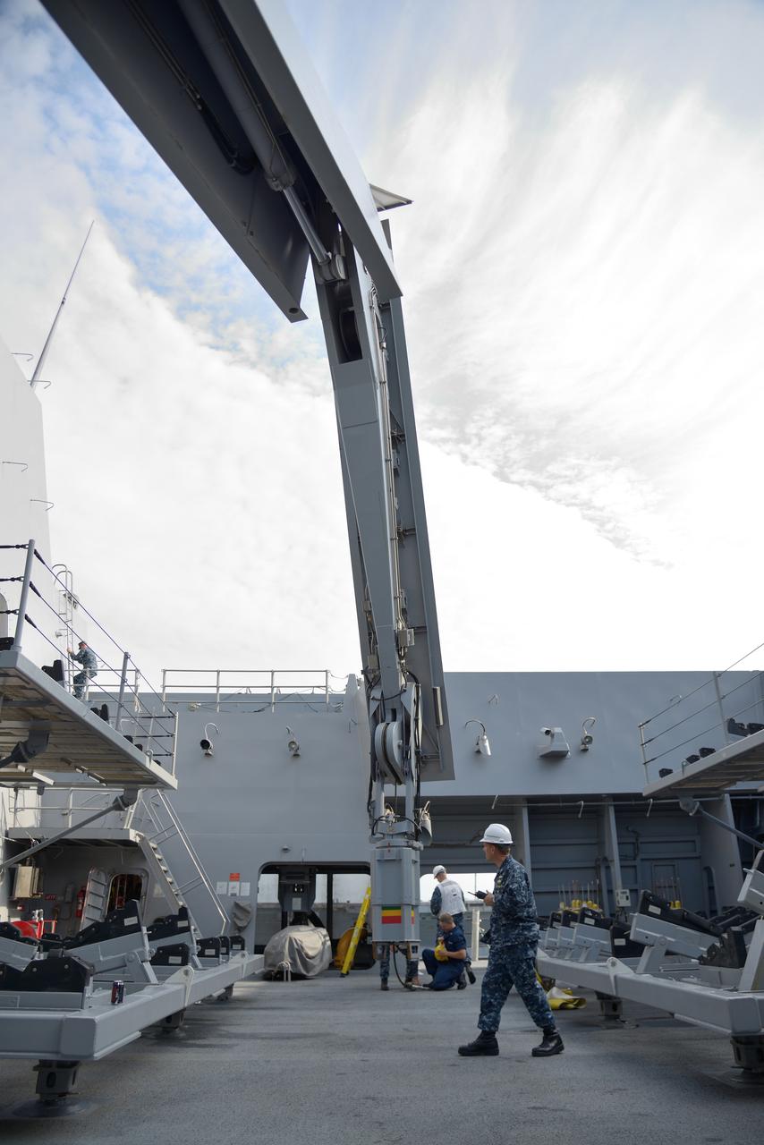 The Orion test capsule undergoes stationary recovery testing in Norfolk, VA on Aug. 13, 2013. NASA and the U.S Navy led the tests using the USS Arlington...The stationary recovery tests allow the teams to demonstrate and evaluate the recovery processes, the hardware and the test personnel in a controlled environment. ..During the test, the U.S Navy Dive Team checked the capsule for hazards while sailors from the USS Arlington approached the capsule in inflatable boats, and towed it back to the ship’s flooded well deck.  Part of Batch image transfer from Flickr.