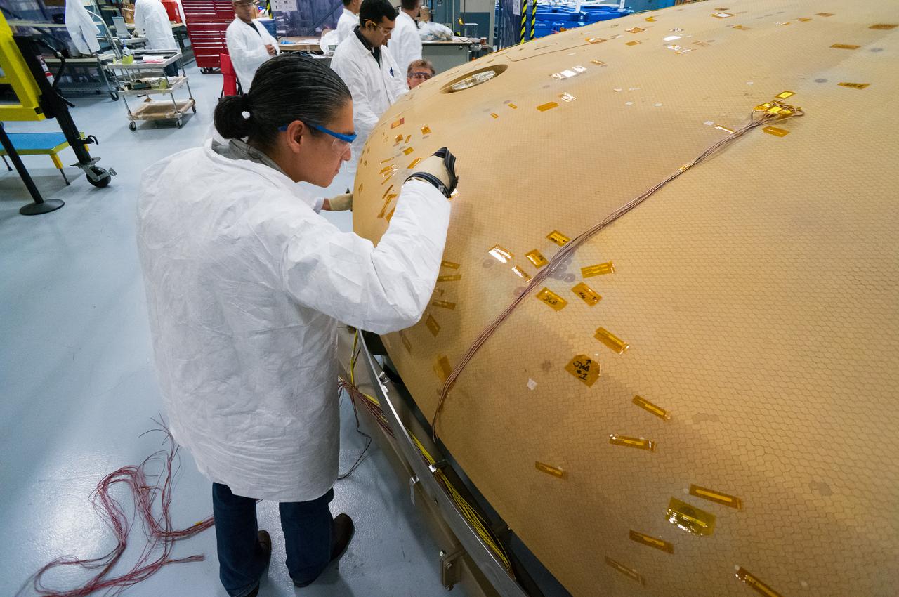 Technicians at Textron in Wimington, MA, inspect the Exploration Flight Test-1 (EFT-1) Orion heat shield after a cold soak test on Nov. 22, 2013. Part of Batch image transfer from Flickr.