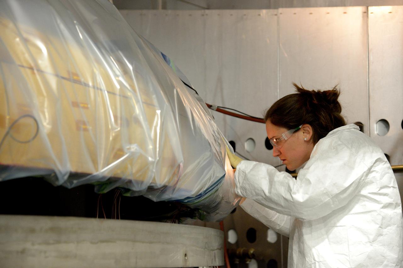 Technicians at Textron in Wimington, MA, inspect the Exploration Flight Test-1 (EFT-1) Orion heat shield after a cold soak test on Nov. 22, 2013. Part of Batch image transfer from Flickr.