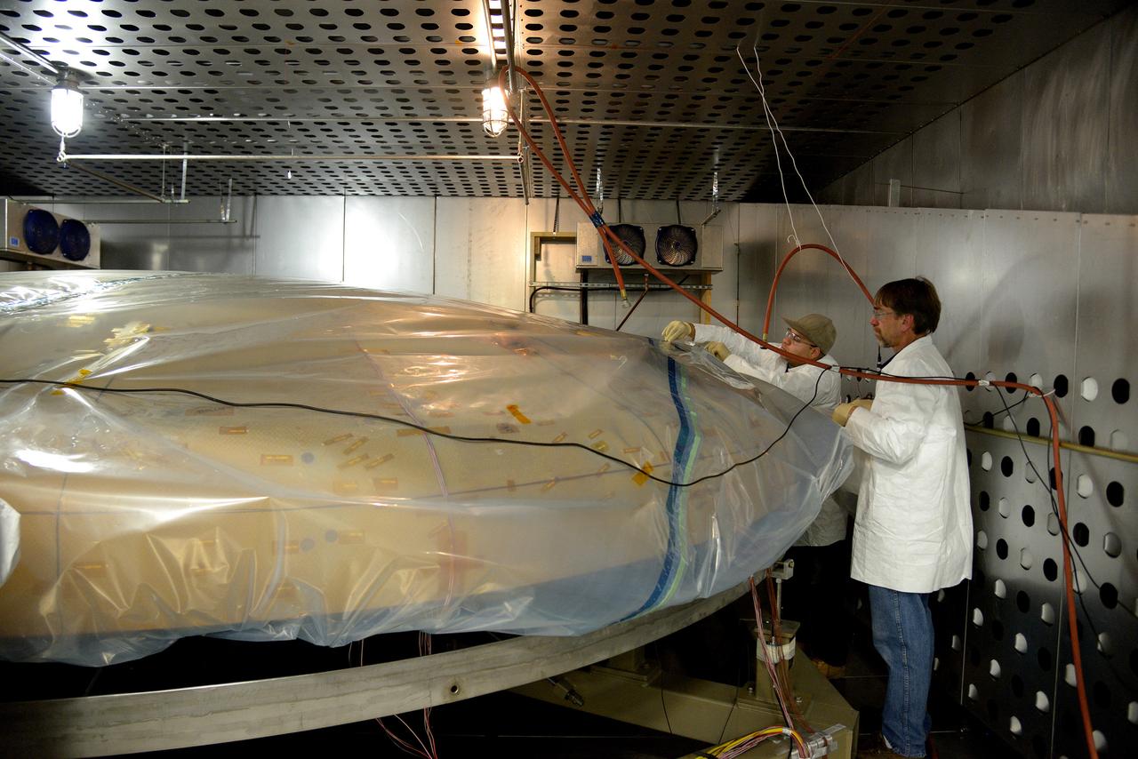 Technicians at Textron in Wimington, MA, inspect the Exploration Flight Test-1 (EFT-1) Orion heat shield after a cold soak test on Nov. 22, 2013. Part of Batch image transfer from Flickr.
